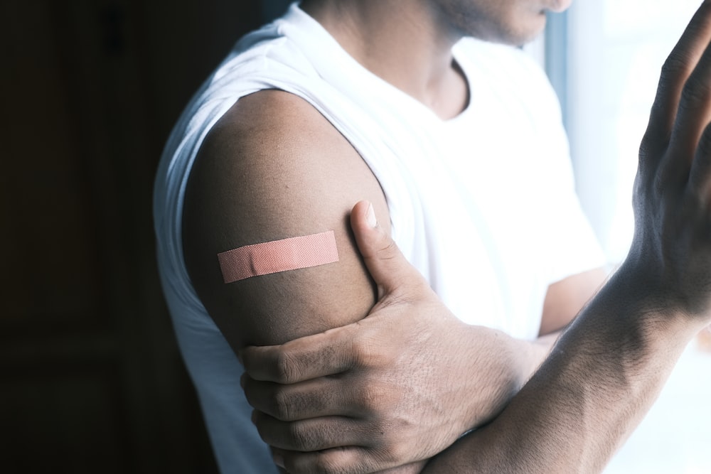A person’s arm with a band-aid