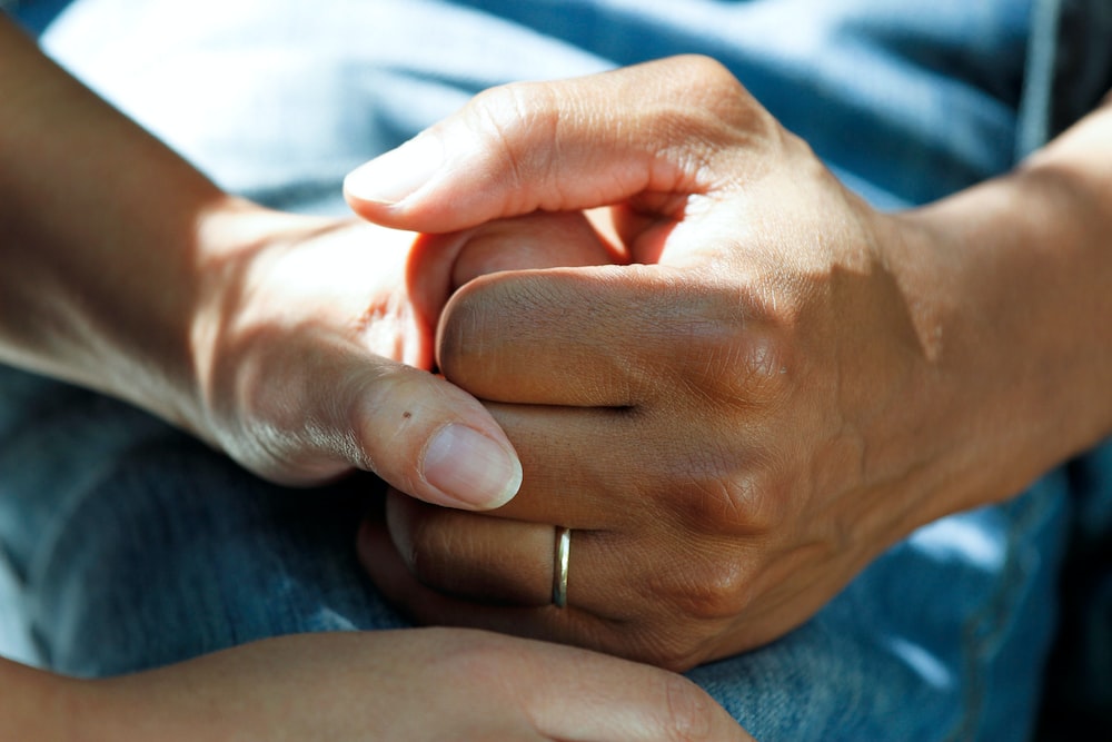 Comforting hand during workers' compensation process.