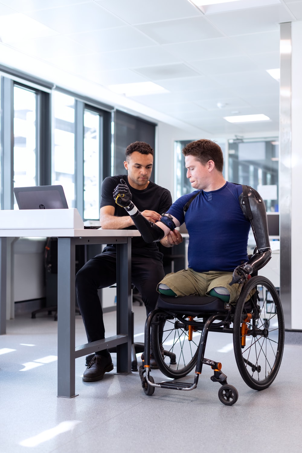 Physical Therapist checking vitals of a man in a wheelchair