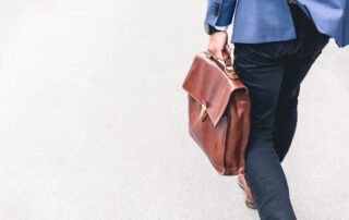 An image of a lawyer in a suit carrying a bag