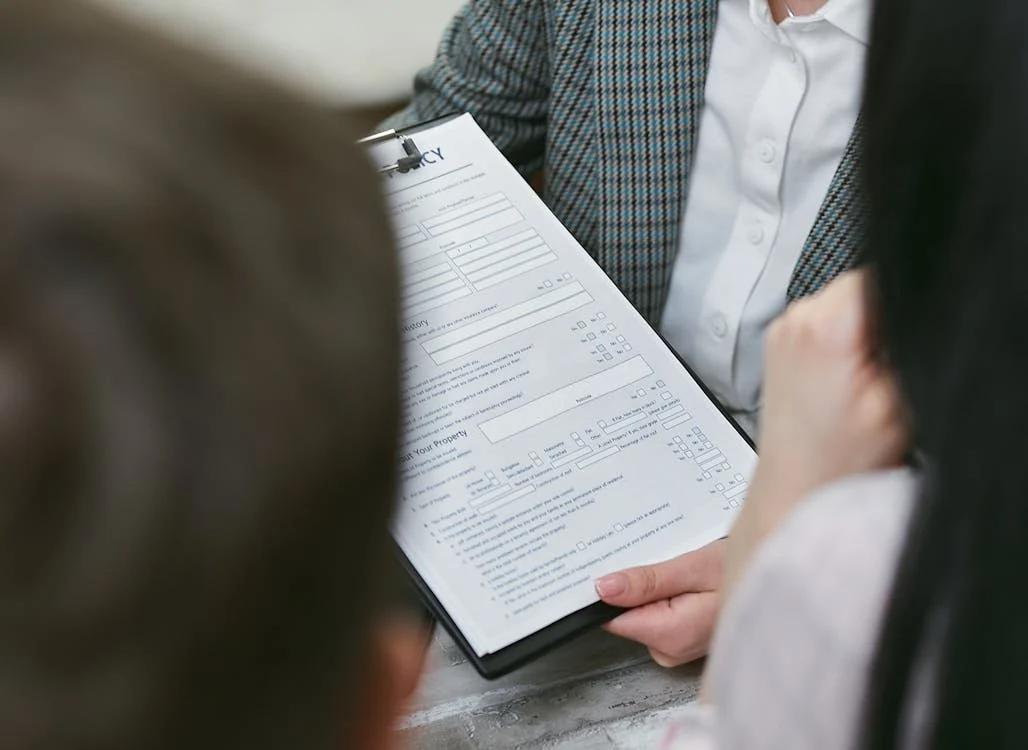 a group of people, including a lawyer, going through forms