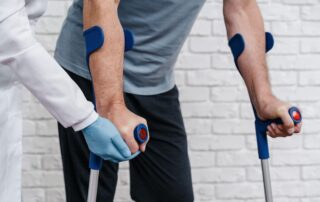 a person walking with the help of a doctor and walking sticks