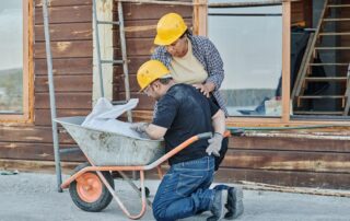 a worker helping out another worker who is injured on cite
