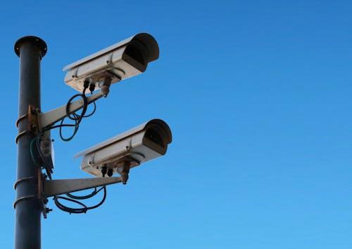 Surveillance cameras against a blue sky