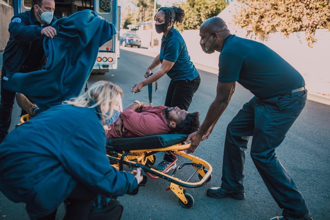 Medical staff members loading an injured worker into an ambulance