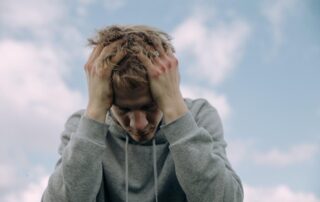 Worker with bruised hands showing signs of physical and psychological workplace trauma