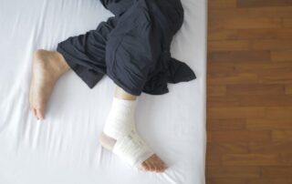 Man with a bandaged foot recovering from a work-related injury