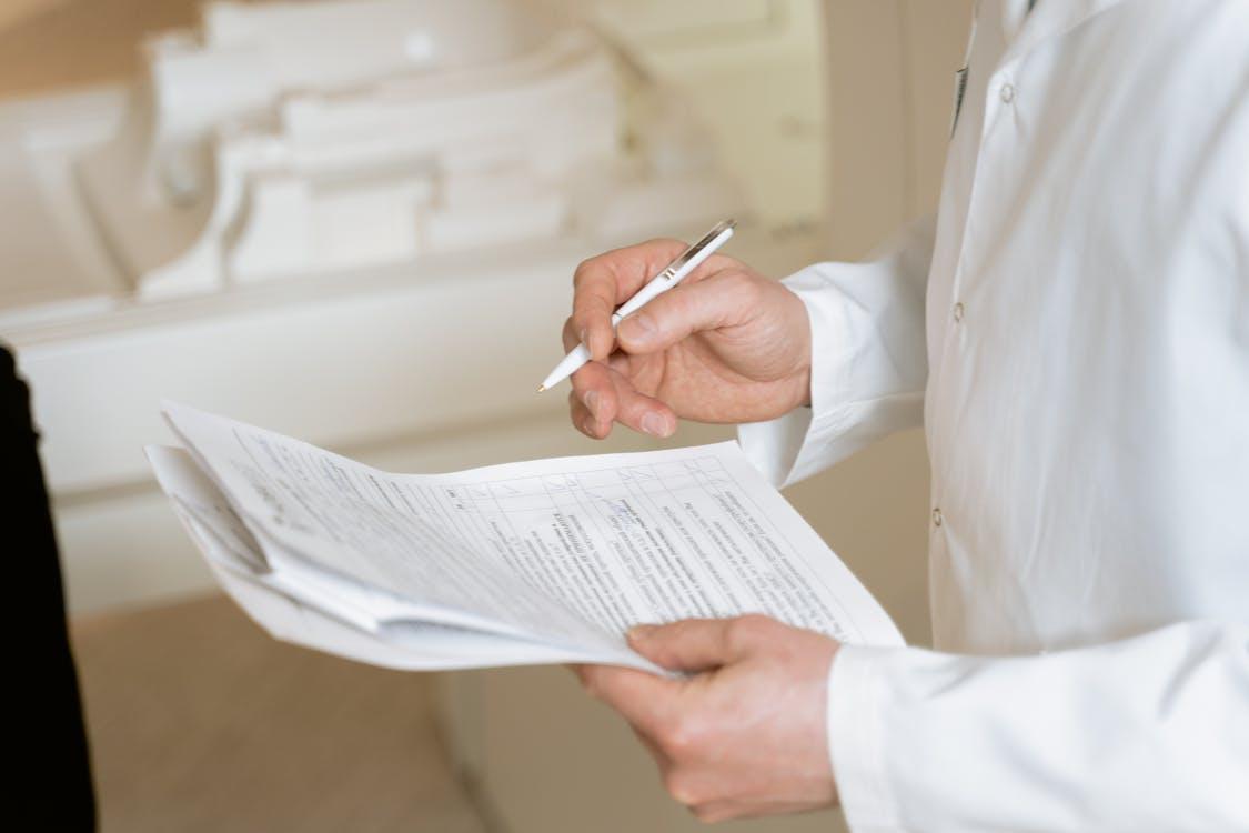 a doctor going through a patient’s medical documents