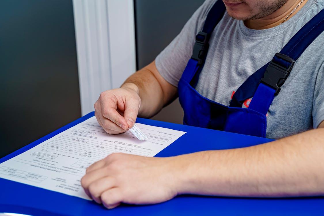 a man in a uniform filling paperwork