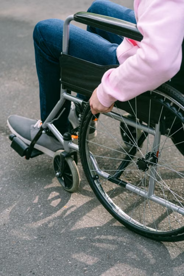 Injured worker independently navigating a wheelchair after a work-related permanent disability