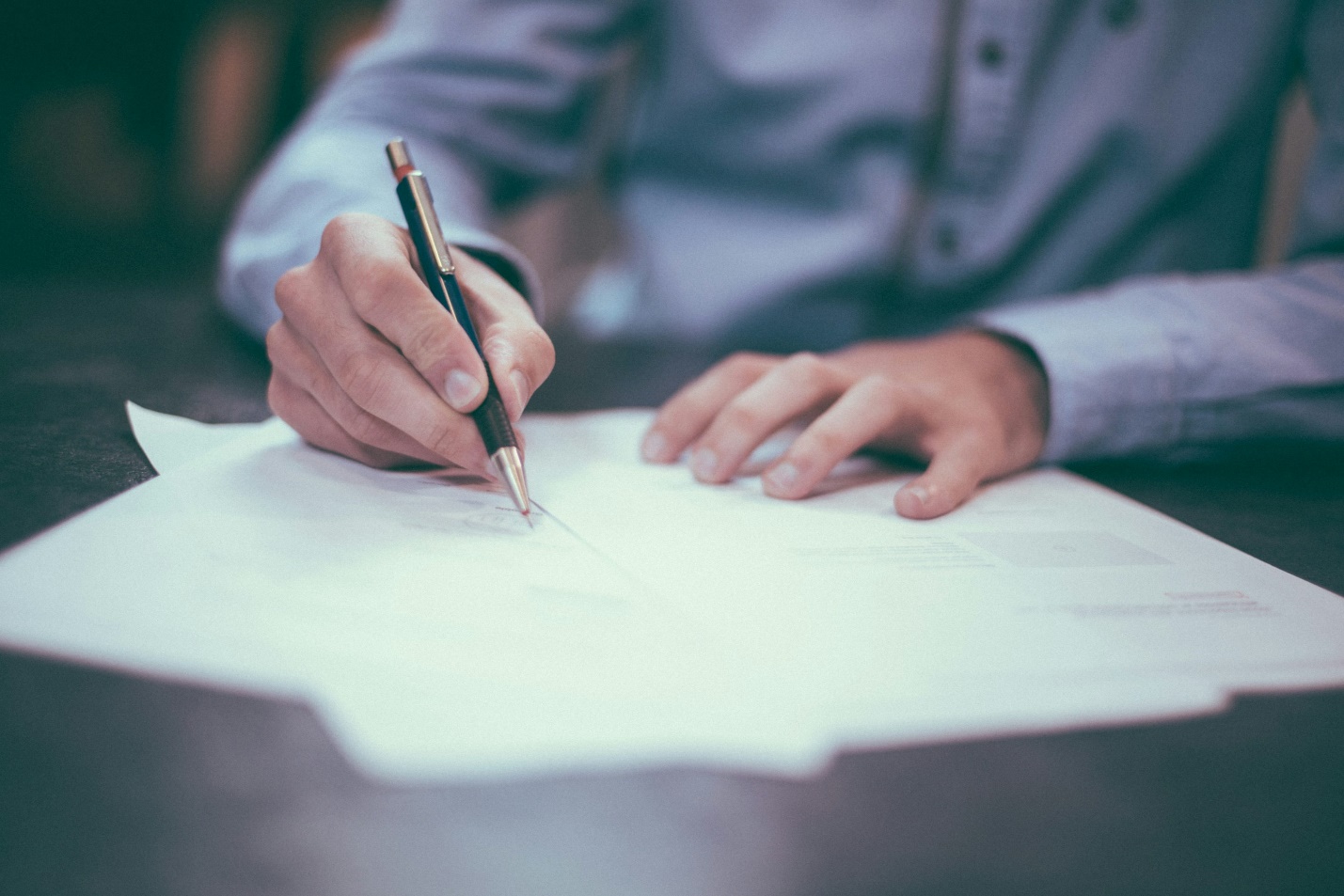 Personal injury lawyer meeting with an injured client to review legal documents related to a workplace injury claim.