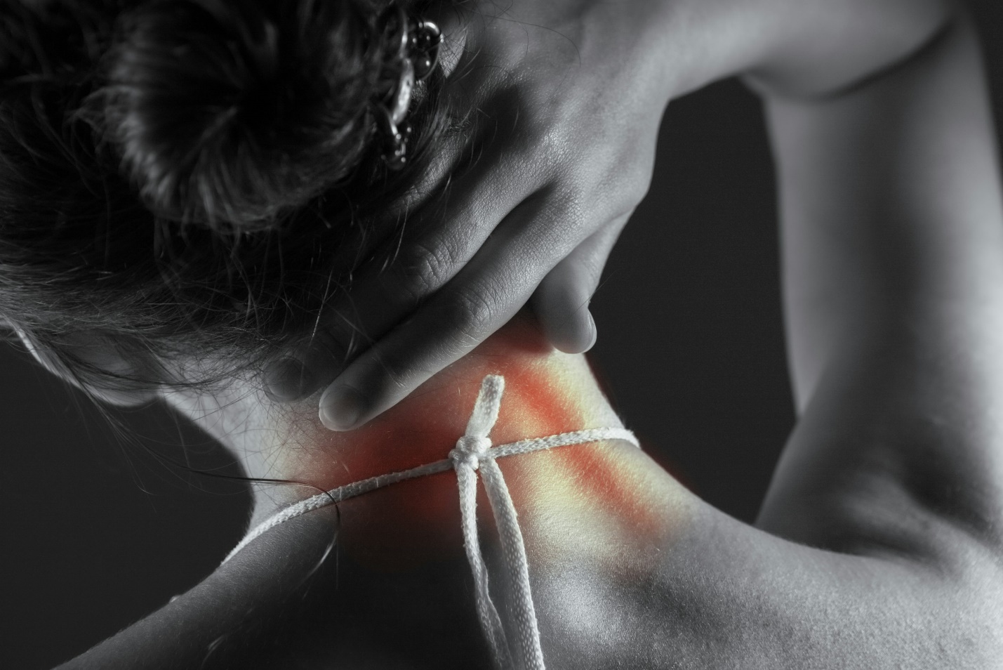Worker holding their neck in pain after developing a work-related neck injury during daily job activities.