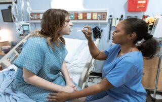 Healthcare professional caring for a patient, after a workplace injury.