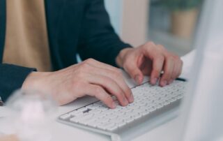 An image of a person typing on a keyboard